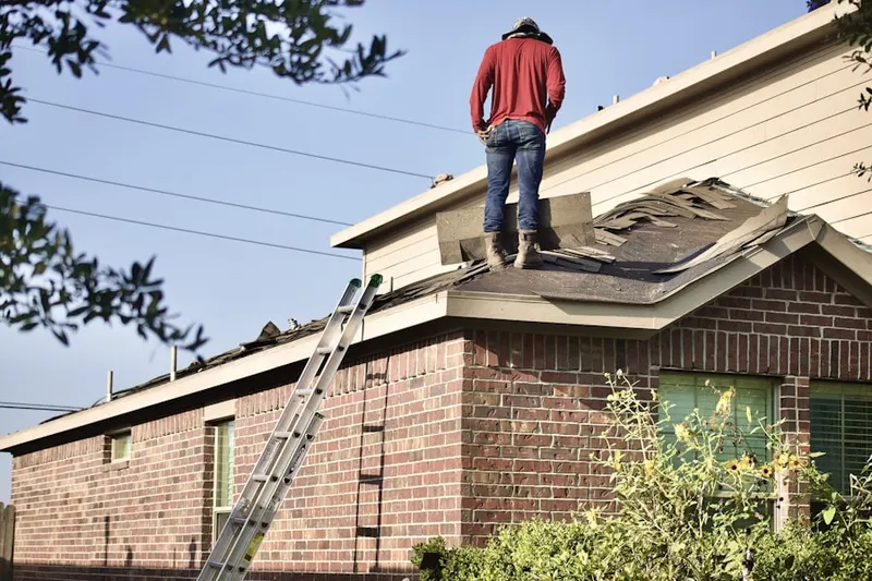 Professional roofer working on a residential roof in Spring Valley Farms